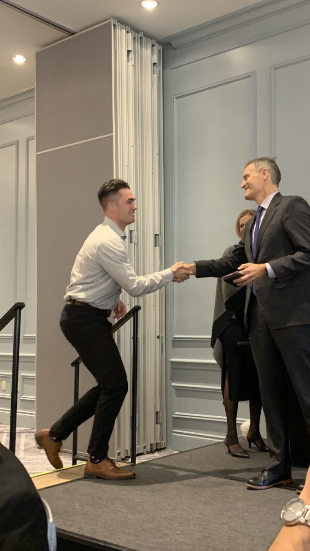 Kyte delivering a powerful keynote speech on a large stage